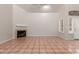 Bright living room boasts tile floors, fireplace, and natural light at 7621 S Bonarden Ln, Tempe, AZ 85284