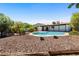 Spacious backyard featuring a kidney-shaped pool and desert landscaping with mountain views at 811 E Brown St, Phoenix, AZ 85020