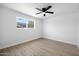 Bright bedroom with wood flooring, ceiling fan and a large window with a view at 811 E Brown St, Phoenix, AZ 85020