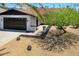 Charming home showcasing xeriscaping, dark rock accents, mature trees, and a two-car garage at 811 E Brown St, Phoenix, AZ 85020