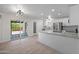 Spacious kitchen with island, white cabinets, stainless steel appliances, and sliding glass doors at 811 E Brown St, Phoenix, AZ 85020