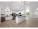 Modern kitchen with white cabinets, stainless steel appliances, granite countertops, and wood flooring at 811 E Brown St, Phoenix, AZ 85020