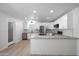 Bright, open kitchen featuring white cabinetry, stainless steel appliances, and granite countertops at 811 E Brown St, Phoenix, AZ 85020