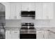Kitchen featuring stainless steel appliances, granite countertops, white cabinetry, and tile backsplash at 811 E Brown St, Phoenix, AZ 85020