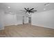 Spacious living room featuring new light wood flooring and a modern ceiling fan at 811 E Brown St, Phoenix, AZ 85020