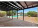 Covered outdoor patio area with brick flooring overlooking a refreshing swimming pool at 811 E Brown St, Phoenix, AZ 85020