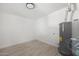 Utility room featuring a modern water heater and sleek, wood-look flooring at 811 E Brown St, Phoenix, AZ 85020