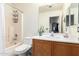 Functional bathroom featuring a shower-tub combo, a single vanity, and a large mirror at 8609 W Eva St, Peoria, AZ 85345