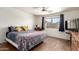 Inviting bedroom with hardwood floors, natural lighting, and a comfortable bed with colorful patterned bedding at 8609 W Eva St, Peoria, AZ 85345