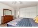Cozy bedroom with hardwood floors, a dark wood dresser, and a plush patterned comforter at 8609 W Eva St, Peoria, AZ 85345