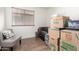 A room filled with boxes, a chair, and a window with blinds at 8609 W Eva St, Peoria, AZ 85345