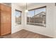 Bright dining area with hardwood floors, a hanging light fixture, and large windows offering a view of the backyard pool at 8609 W Eva St, Peoria, AZ 85345