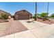 A single-story home with a large driveway, desert landscaping, and attached two-car garage at 8609 W Eva St, Peoria, AZ 85345