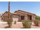Single-story home with mature desert landscaping and an attached two-car garage at 8609 W Eva St, Peoria, AZ 85345