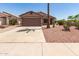 Single-story home showcasing desert landscaping, a two-car garage, and concrete driveway at 8609 W Eva St, Peoria, AZ 85345
