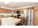 Well-equipped kitchen featuring wood cabinets, modern appliances, and an island with a sink and countertop space at 8609 W Eva St, Peoria, AZ 85345