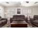 Bright living room with plantation shutters, laminate flooring, and comfortable furniture at 8609 W Eva St, Peoria, AZ 85345