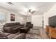 Open-concept living room featuring plank flooring, a ceiling fan, and plantation shutters at 8609 W Eva St, Peoria, AZ 85345