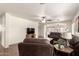 Spacious living room with modern ceiling fan and view to kitchen and eating area at 8609 W Eva St, Peoria, AZ 85345