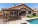 Back of home with pool, turf, and tile roof at 8609 W Eva St, Peoria, AZ 85345