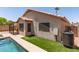 Back of home with pool, turf, and tile roof at 8609 W Eva St, Peoria, AZ 85345