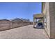 Spacious gravel backyard with covered patio at 8769 W Washington St, Tolleson, AZ 85353