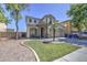 Charming two-story home featuring a stone-accented entrance, well-maintained lawn and a two-car garage at 8769 W Washington St, Tolleson, AZ 85353