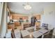 Well-lit kitchen with wooden cabinets, stainless steel appliances, a kitchen island, and adjacent dining space at 8769 W Washington St, Tolleson, AZ 85353