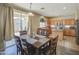 Bright kitchen and dining area featuring wood cabinets, an island, and a sliding glass door to the backyard at 8769 W Washington St, Tolleson, AZ 85353