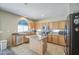Bright kitchen with wood cabinets, stainless appliances, and a center island offering ample counter space at 8769 W Washington St, Tolleson, AZ 85353