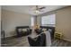 Bright living room with plank flooring, neutral paint, lots of natural light and stylish furniture at 8769 W Washington St, Tolleson, AZ 85353