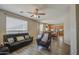 Open-concept living room featuring plank flooring, neutral walls, and views into the dining and kitchen areas at 8769 W Washington St, Tolleson, AZ 85353