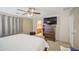 Serene main bedroom with an ensuite bathroom, offering privacy and convenience with a ceiling fan at 8769 W Washington St, Tolleson, AZ 85353