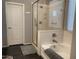Bright bathroom featuring a glass-enclosed shower and soaking tub at 9141 W Dreyfus Dr, Peoria, AZ 85381