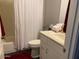 Neat bathroom featuring a shower with a white curtain and a vanity with cabinet storage at 9141 W Dreyfus Dr, Peoria, AZ 85381