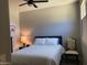 Neutral bedroom offering a comfortable bed, soft lighting, and an overhead ceiling fan at 9141 W Dreyfus Dr, Peoria, AZ 85381
