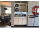 Dining area with built-in bar cabinets, seating for six, and modern decorations at 9141 W Dreyfus Dr, Peoria, AZ 85381
