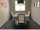 Cozy dining room with a modern light fixture, seating for six, and tiled floors at 9141 W Dreyfus Dr, Peoria, AZ 85381