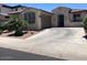 Charming single-story home featuring a well-manicured lawn and a two-car attached garage at 9141 W Dreyfus Dr, Peoria, AZ 85381