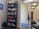 Well-lit hallway featuring bookshelf, office chair, and view through arched doorway at 9141 W Dreyfus Dr, Peoria, AZ 85381