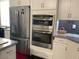 Kitchen features stainless steel appliances, granite countertops and white cabinetry at 9141 W Dreyfus Dr, Peoria, AZ 85381