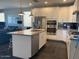 Modern kitchen with stainless steel appliances, granite countertops, and white cabinetry at 9141 W Dreyfus Dr, Peoria, AZ 85381