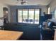 Comfortable living room showcasing dark tiled floors and sliding glass doors to the backyard at 9141 W Dreyfus Dr, Peoria, AZ 85381