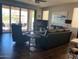 Inviting living room with stylish furniture, dark floors, and sliding glass doors to the outside at 9141 W Dreyfus Dr, Peoria, AZ 85381