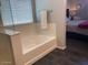 Modern bathroom features separate shower and tub areas and neutral tile flooring at 9141 W Dreyfus Dr, Peoria, AZ 85381