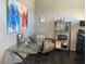 Office featuring large abstract painting, glass-topped desk and view to the outdoors at 9141 W Dreyfus Dr, Peoria, AZ 85381