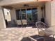 Covered patio includes ceiling fan, exterior shades, and a paved seating area at 9141 W Dreyfus Dr, Peoria, AZ 85381