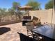 Paver patio with multiple seating areas and desert landscape views at 9141 W Dreyfus Dr, Peoria, AZ 85381