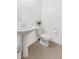 Classic half-bath featuring a pedestal sink, neutral tile floors, and bright lighting at 9582 W Albert Ln, Peoria, AZ 85382