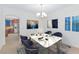 Bright dining room featuring a marble table, modern chandelier, and stylish decor at 9582 W Albert Ln, Peoria, AZ 85382